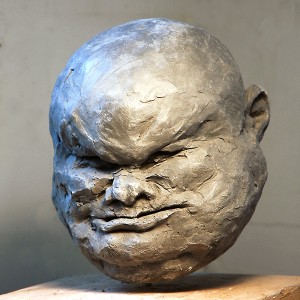 photograph of clay figurative sculpture of old man's head