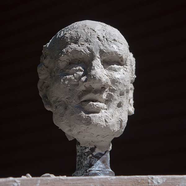sculpture of old man's head in clay